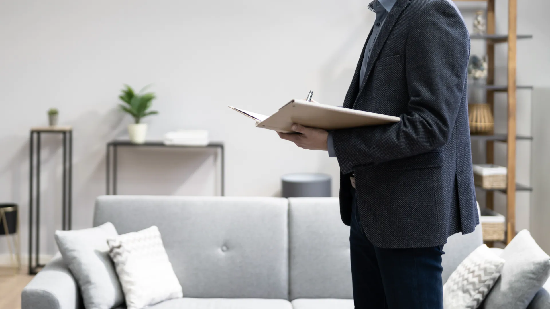 a home inspector holding a clipboard in a living room during home inspection austell ga