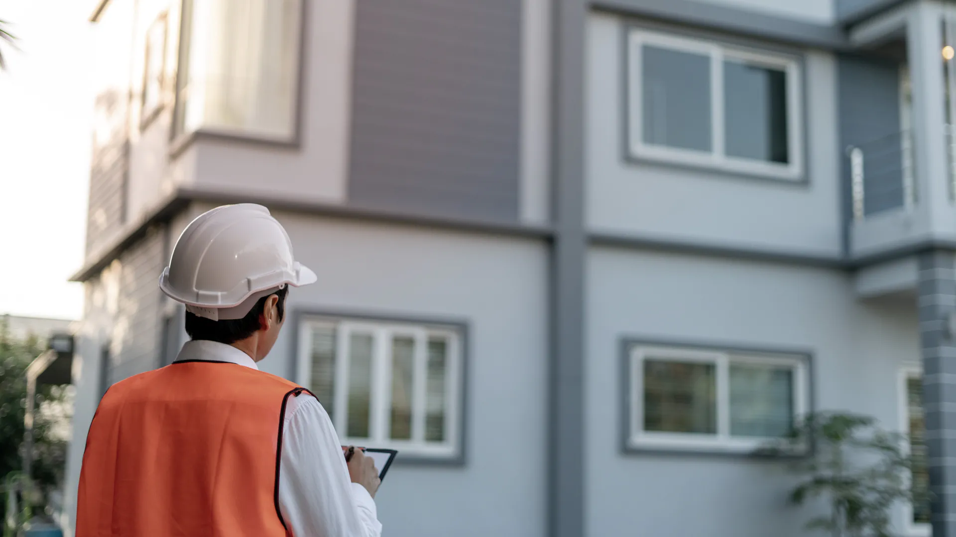 close up of a home inspector using a clipboard in front of a house during home inspection austell ga